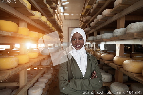 Image of African black muslim business woman in local cheese production company