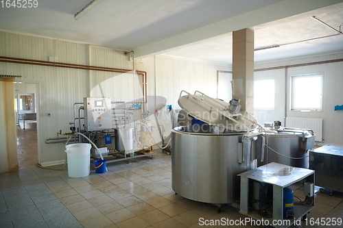 Image of Cheese factory production shelves with aging old cheese