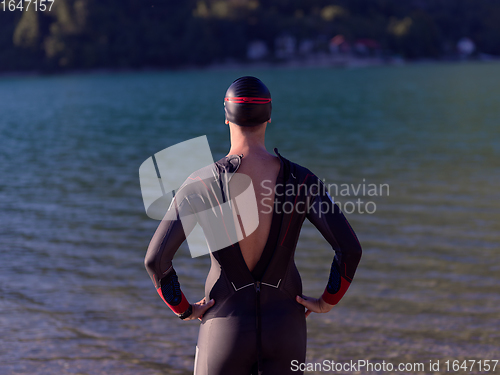 Image of triathlete swimmer portrait wearing wetsuit on training