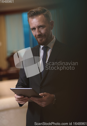 Image of business man using tablet computer