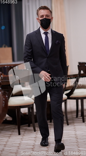 Image of business man wearing protective face mask at office