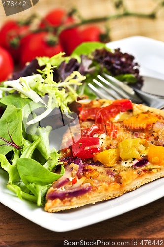 Image of Vegetarian pizza with salad