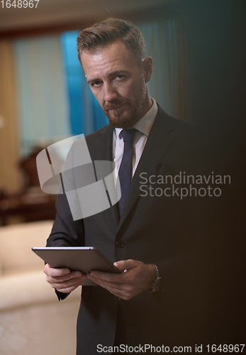 Image of business man using tablet computer