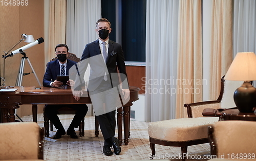 Image of business team wearing crona virus protection face mask