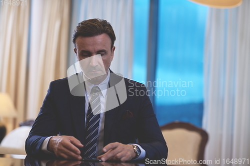 Image of business man using smart phone at luxury office