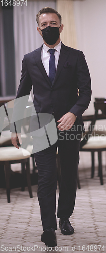 Image of business man wearing protective face mask at office