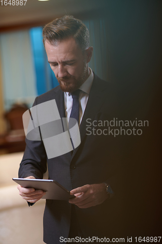 Image of business man using tablet computer