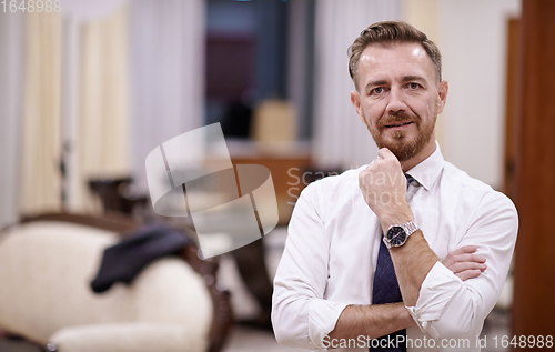 Image of Portrait of smiling ceo at modern office in stylish suit