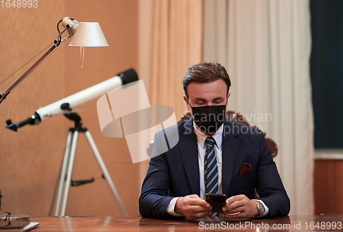 Image of business man wearing protective face mask at office