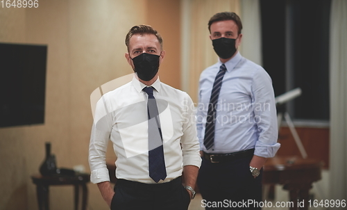 Image of business team wearing crona virus protection face mask