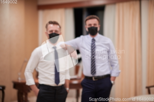 Image of business team wearing crona virus protection face mask