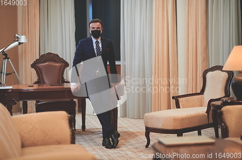 Image of business man wearing protective face mask at office