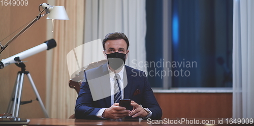 Image of business man wearing protective face mask at office