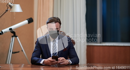 Image of business man wearing protective face mask at office