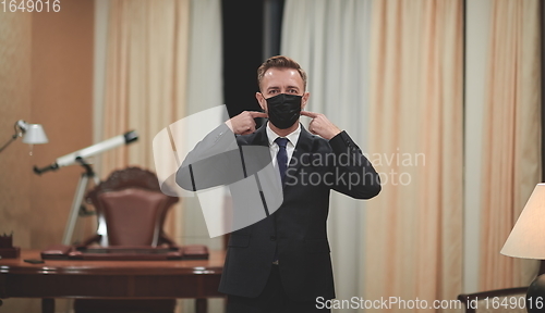 Image of business man wearing protective face mask at office