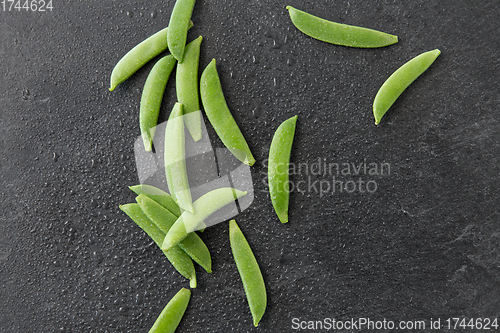 Image of peas on wet slate stone background