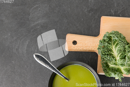 Image of kale cabbage cream soup in bowl with spoon