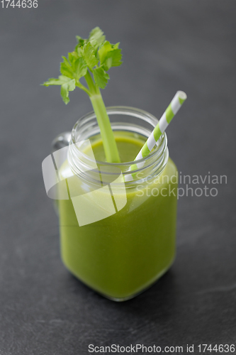 Image of close up of glass mug with green celery juice