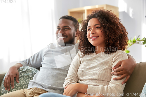 Image of happy african american couple hugging at home