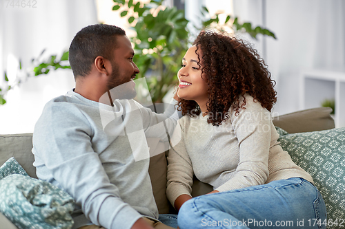 Image of african american couple on sofa talking at home