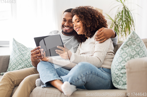 Image of african american couple with tablet pc at home