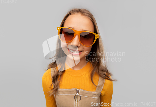 Image of smiling young teenage girl in sunglasses