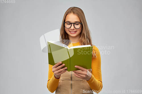 Image of teenage student girl in glasses reading book