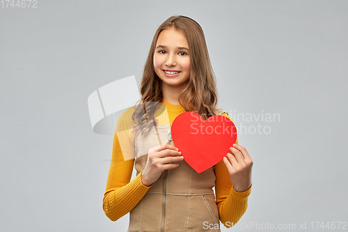 Image of smiling teenage girl with red heart