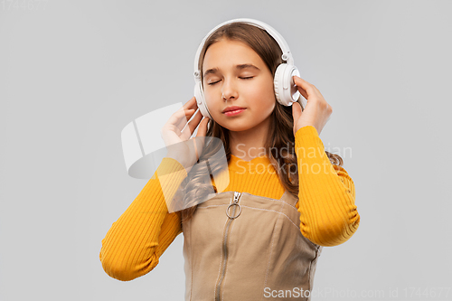 Image of teenage girl in headphones listening to music