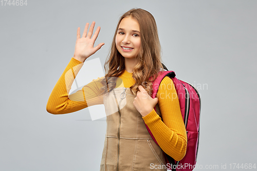 Image of smiling teenage student girl with backpack