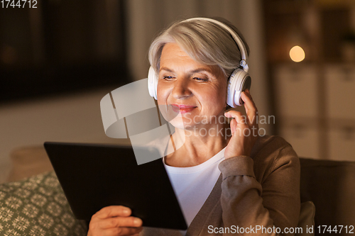 Image of senior woman in headphones listening to music