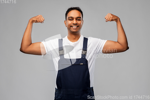 Image of smiling indian worker or builder showing his power