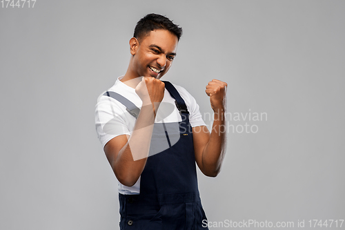 Image of happy indian worker or builder celebrating success