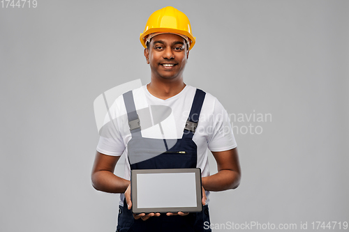 Image of happy indian builder in helmet with tablet pc