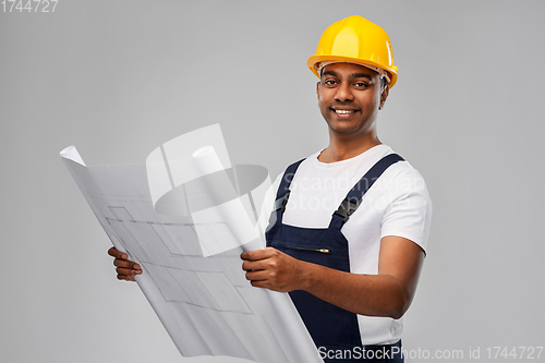 Image of happy indian builder in helmet with blueprint