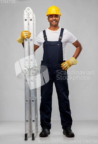 Image of happy indian builder in helmet with ladder