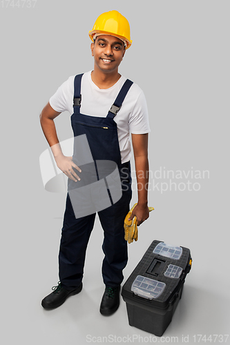 Image of happy indian builder in helmet with tool box