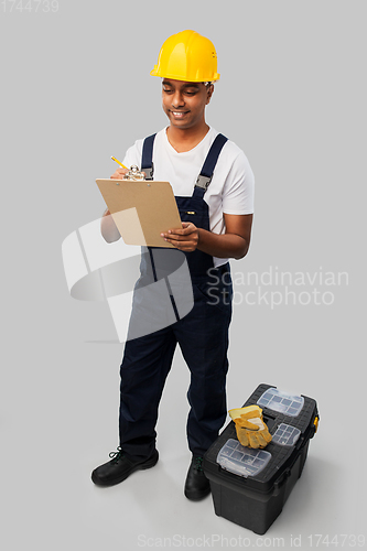 Image of builder in helmet with clipboard and tool box