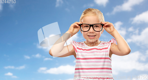 Image of smiling cute little girl in black glasses