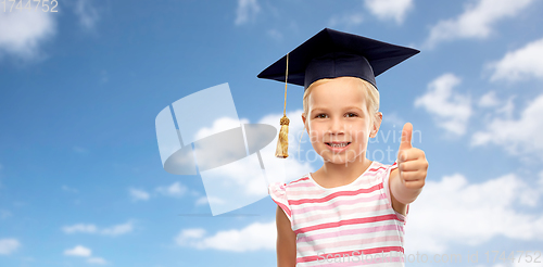 Image of little girl in mortarboard showing thumbs up