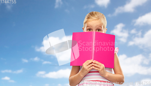 Image of little girl hiding over book