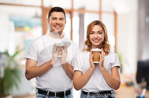 Image of portrait of happy couple with takeaway coffee cups