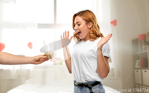 Image of happy couple with gift on valentines day at home