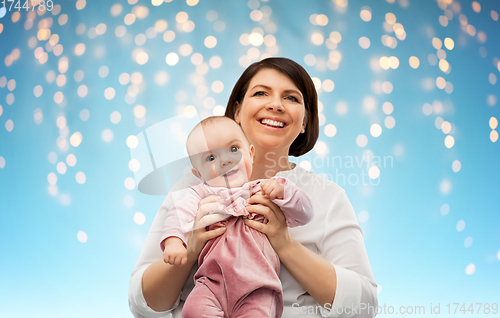 Image of happy middle-aged mother with little baby daughter