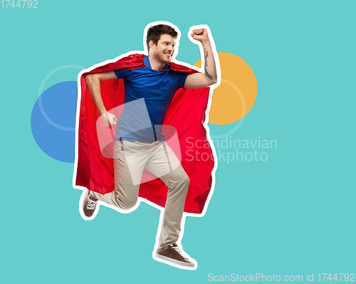 Image of man in red superhero cape jumping in air