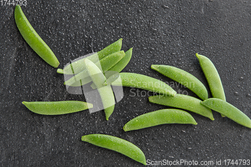 Image of peas on wet slate stone background