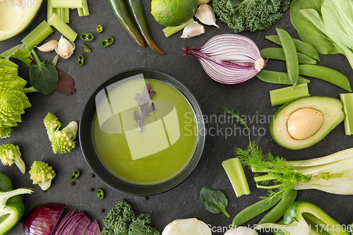 Image of green vegetables and cream soup in ceramic bowl