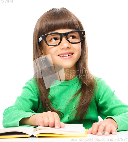 Image of Little girl is reading a book