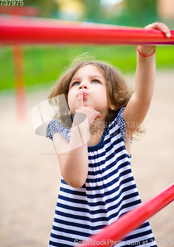 Image of Cute little girl is playing in playground