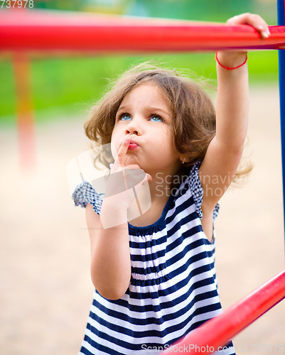 Image of Cute little girl is playing in playground